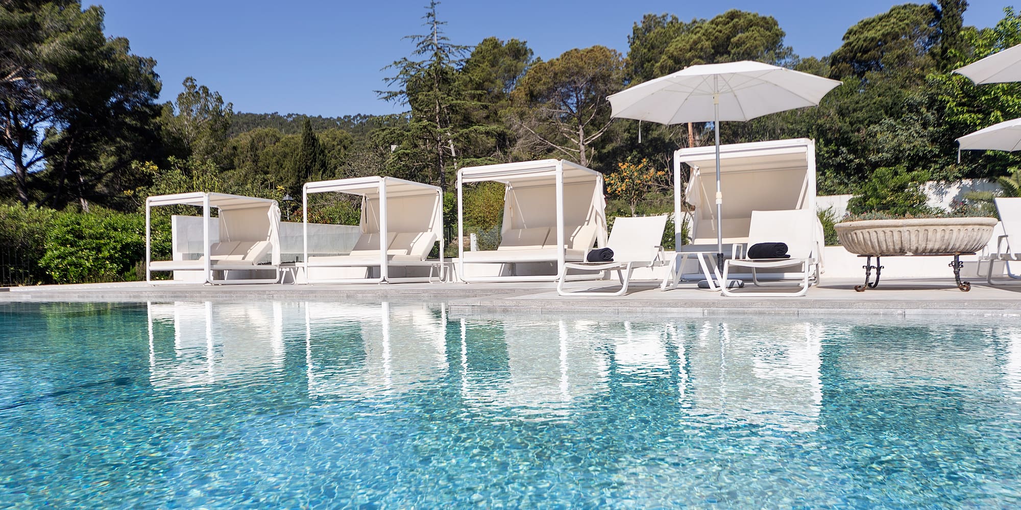 a pool with chairs and umbrellas