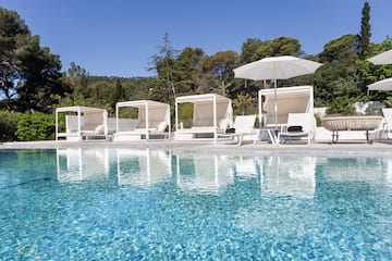 a pool with chairs and umbrellas