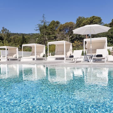 a pool with chairs and umbrellas