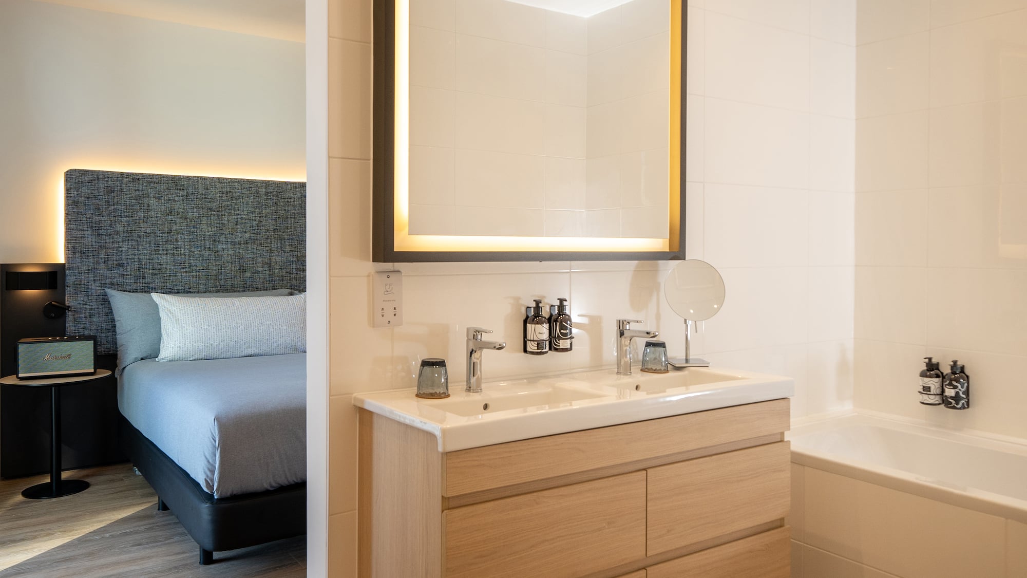 a bathroom with a mirror and a bathtub