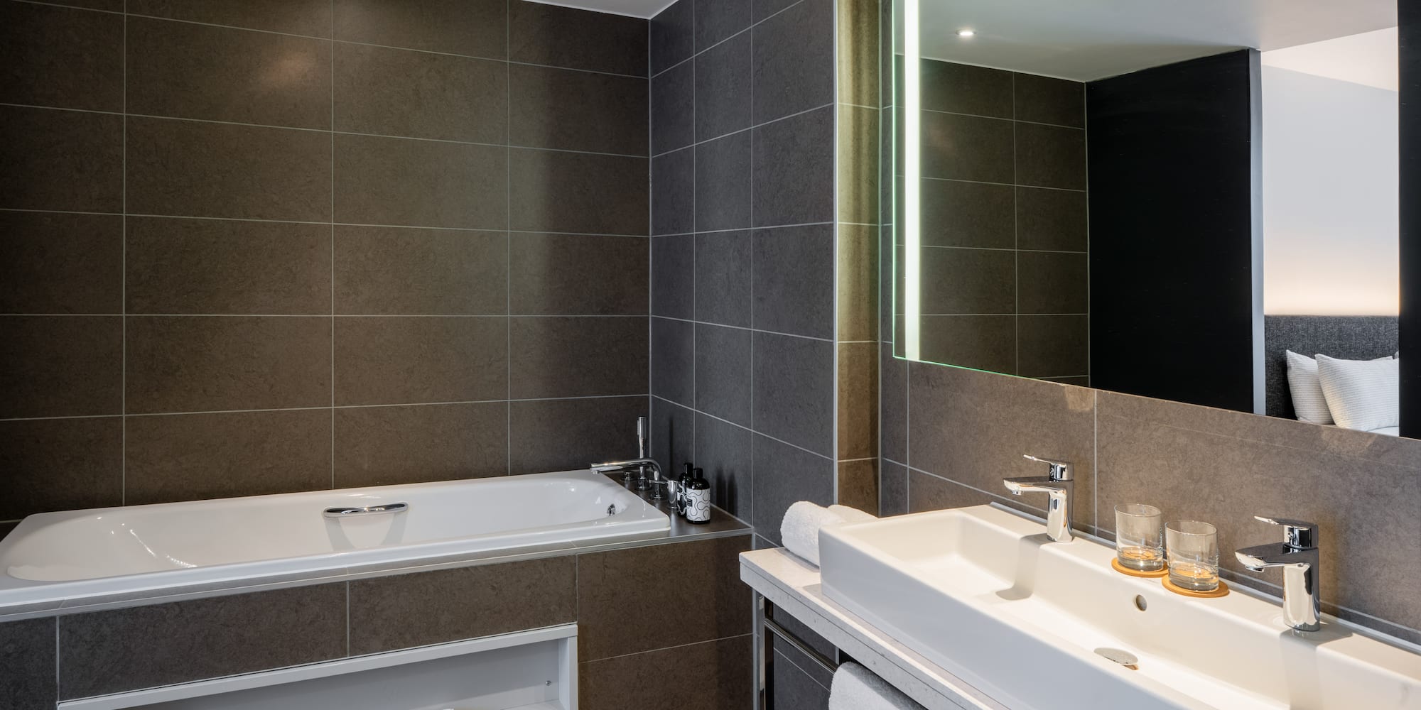 a bathroom with a bathtub and a mirror