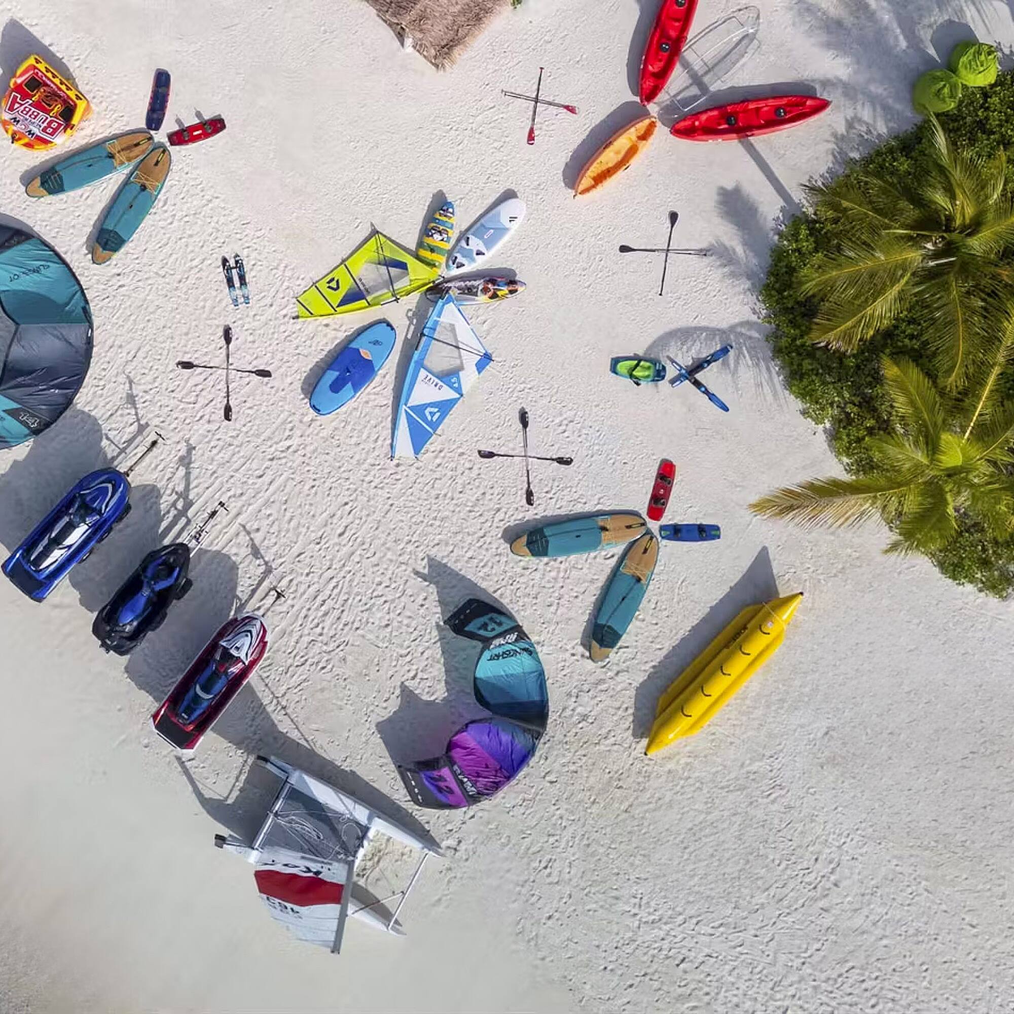 a group of kayaks and boats on a beach
