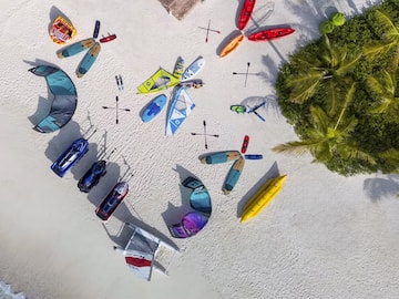 a group of kayaks and boats on a beach