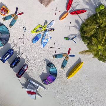 a group of kayaks and boats on a beach