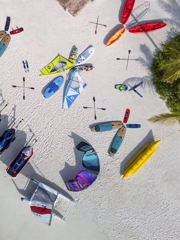 a group of kayaks and boats on a beach