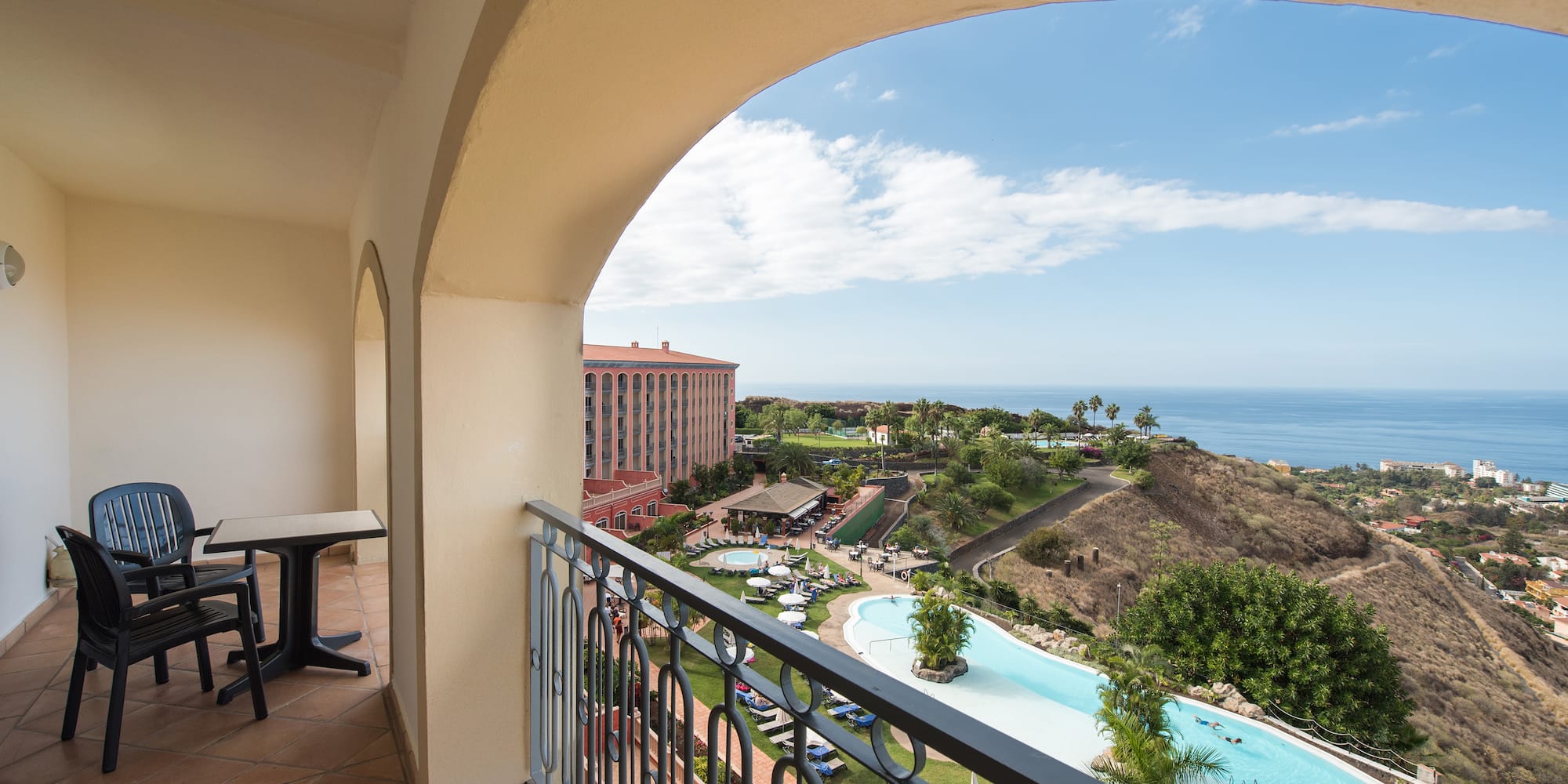 a balcony with a pool and a table