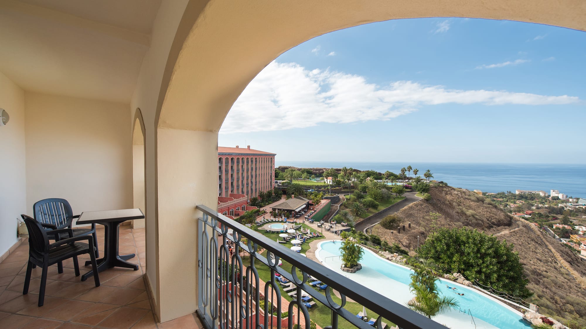 a balcony with a pool and a table