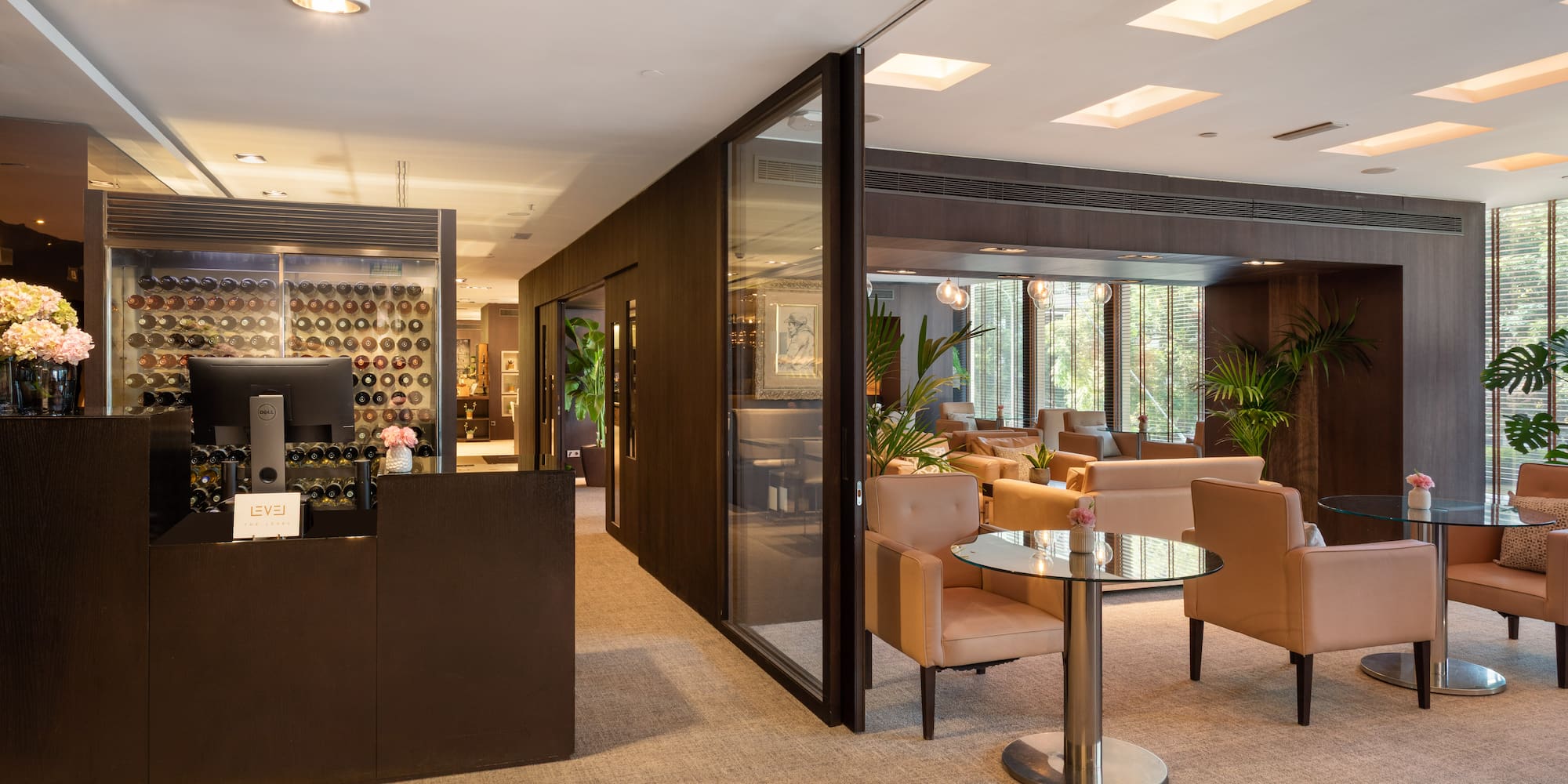 a room with a glass wall and chairs