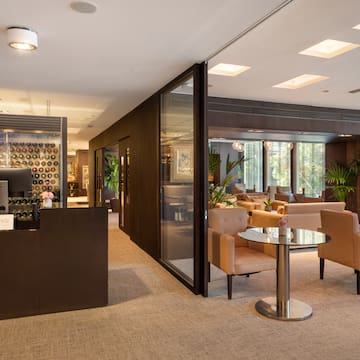 a room with a glass wall and chairs