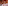 Elegant dining room with set table, lamp, crystal glasses, and patterned chairs.