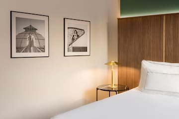 a bedroom with a bed and a lamp