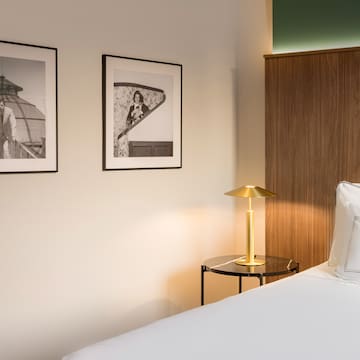 a bedroom with a bed and a lamp