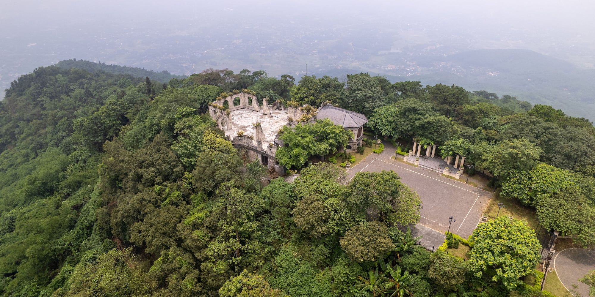 an aerial view of a building surrounded by trees