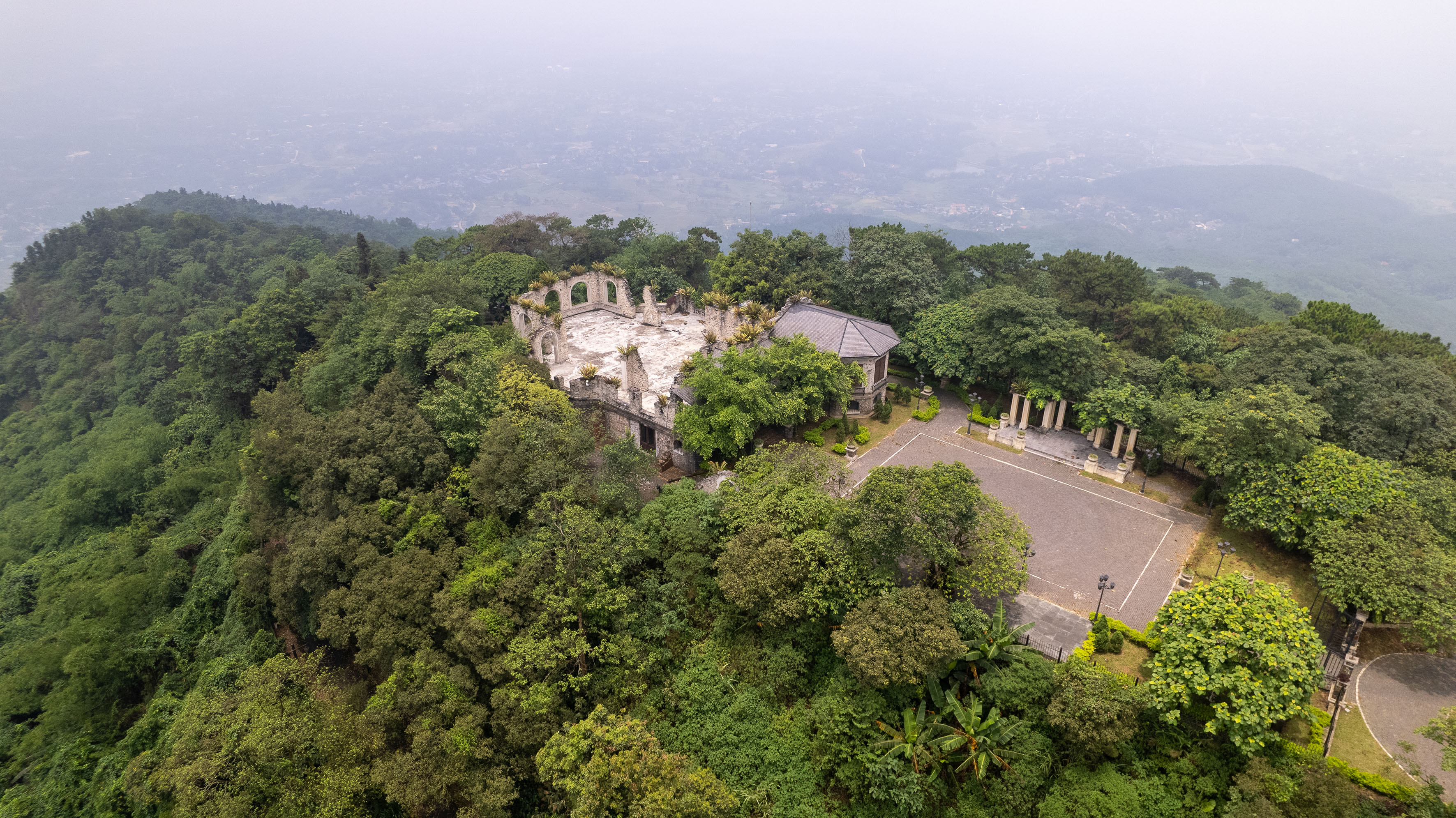 an aerial view of a building surrounded by trees