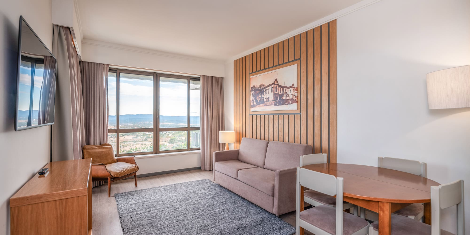 a room with a couch and table and chairs