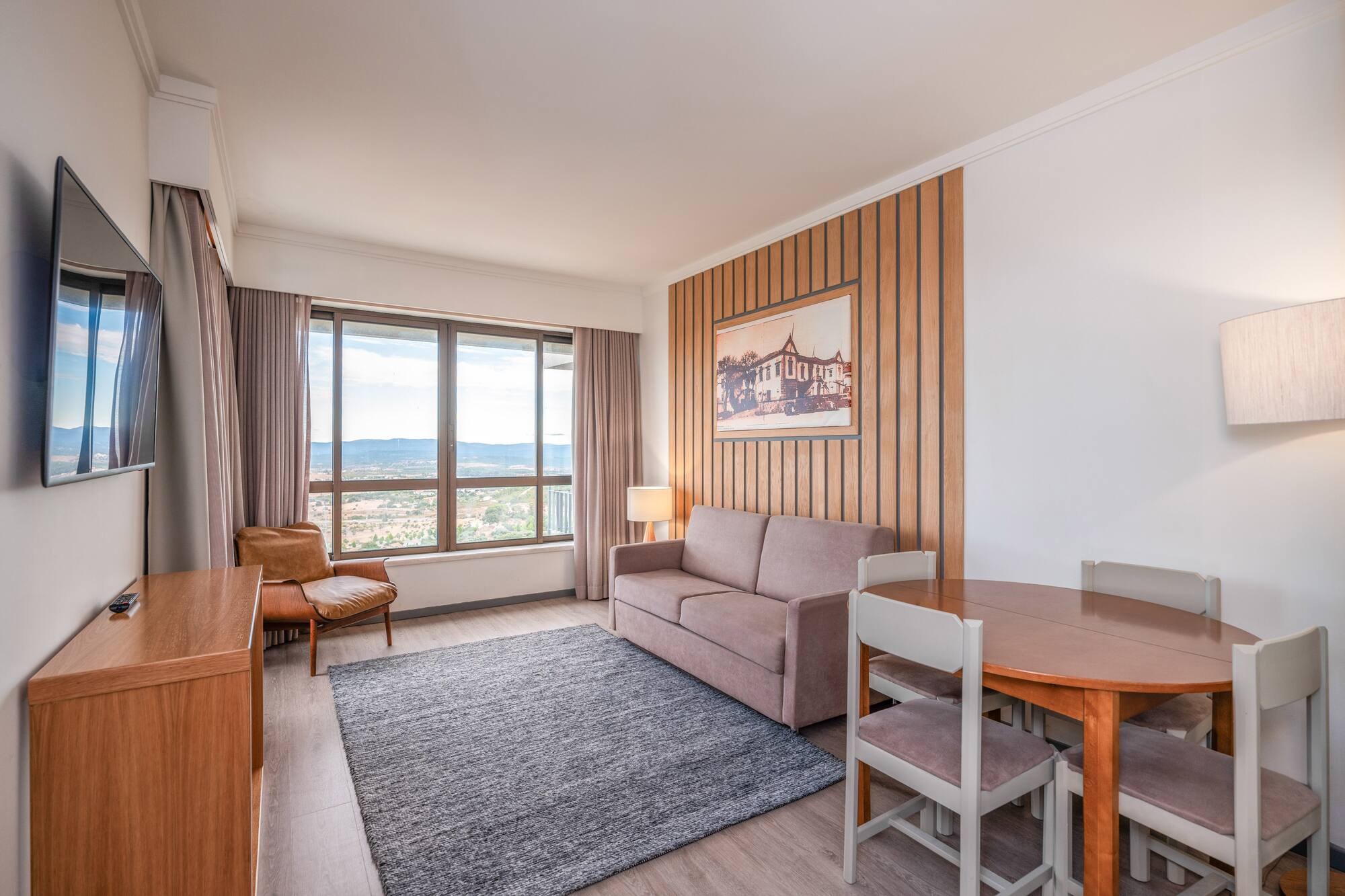 a room with a couch and table and chairs