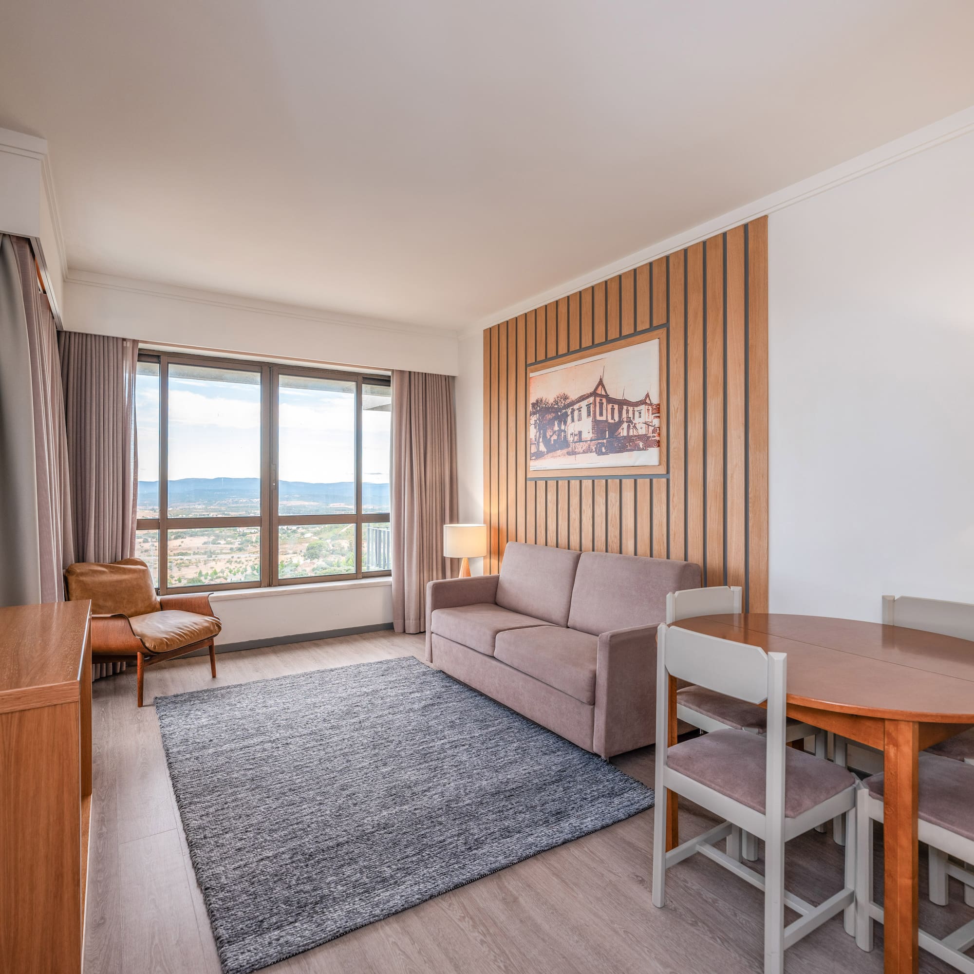 a room with a couch and table and chairs