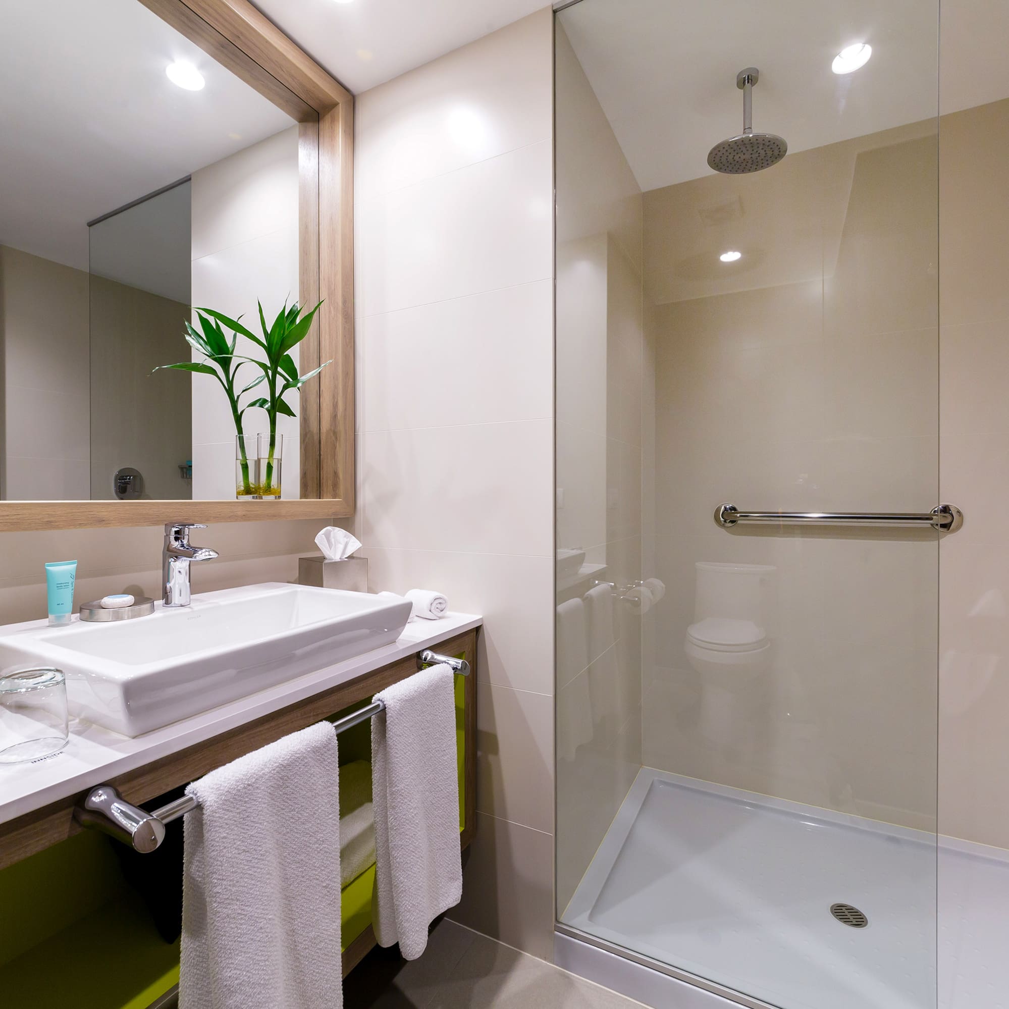 a bathroom with a glass shower and sink