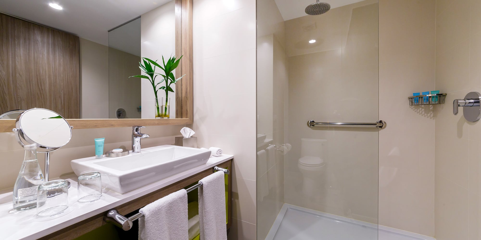 a bathroom with a glass shower and sink