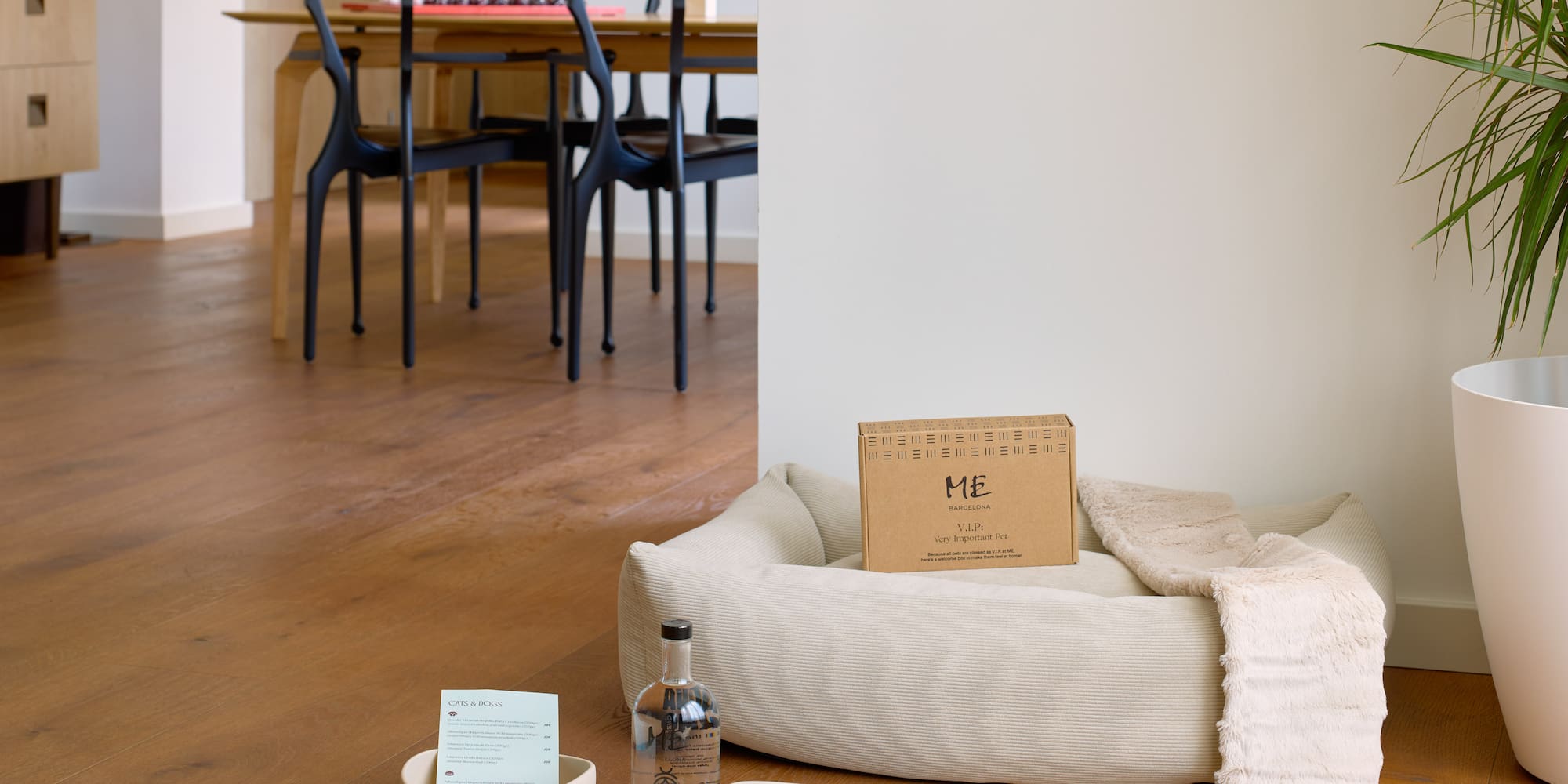 a dog bed with a bottle and a bottle of alcohol on it