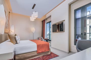 a bedroom with a bed and a television