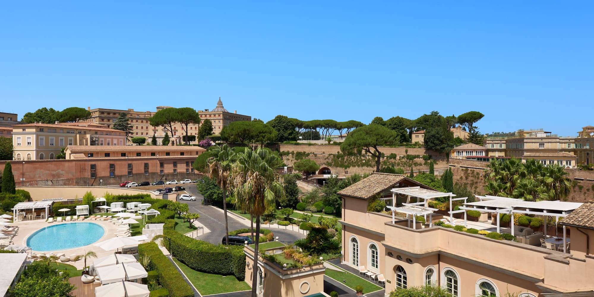 a group of buildings with trees and a pool