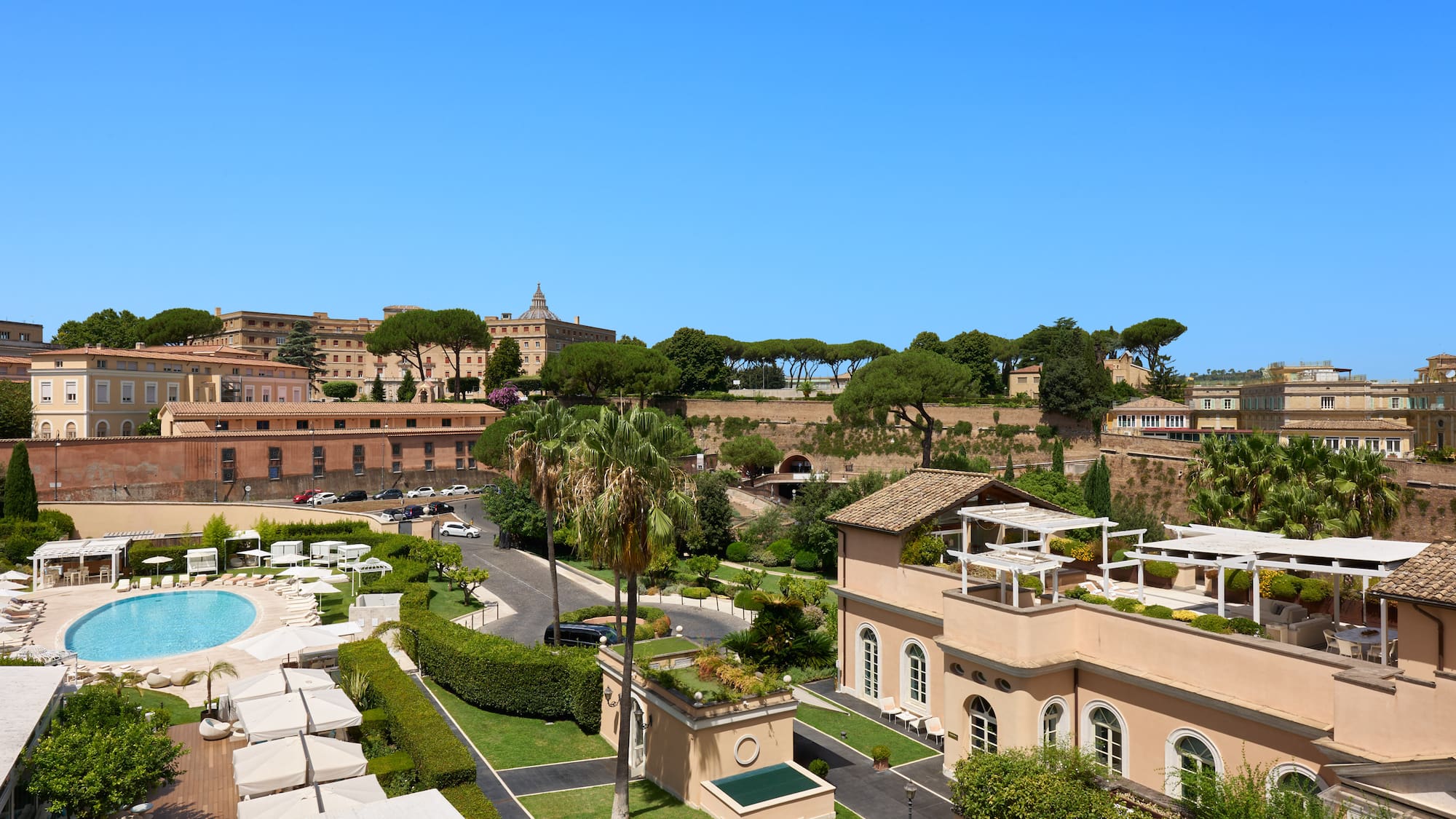 a group of buildings with trees and a pool
