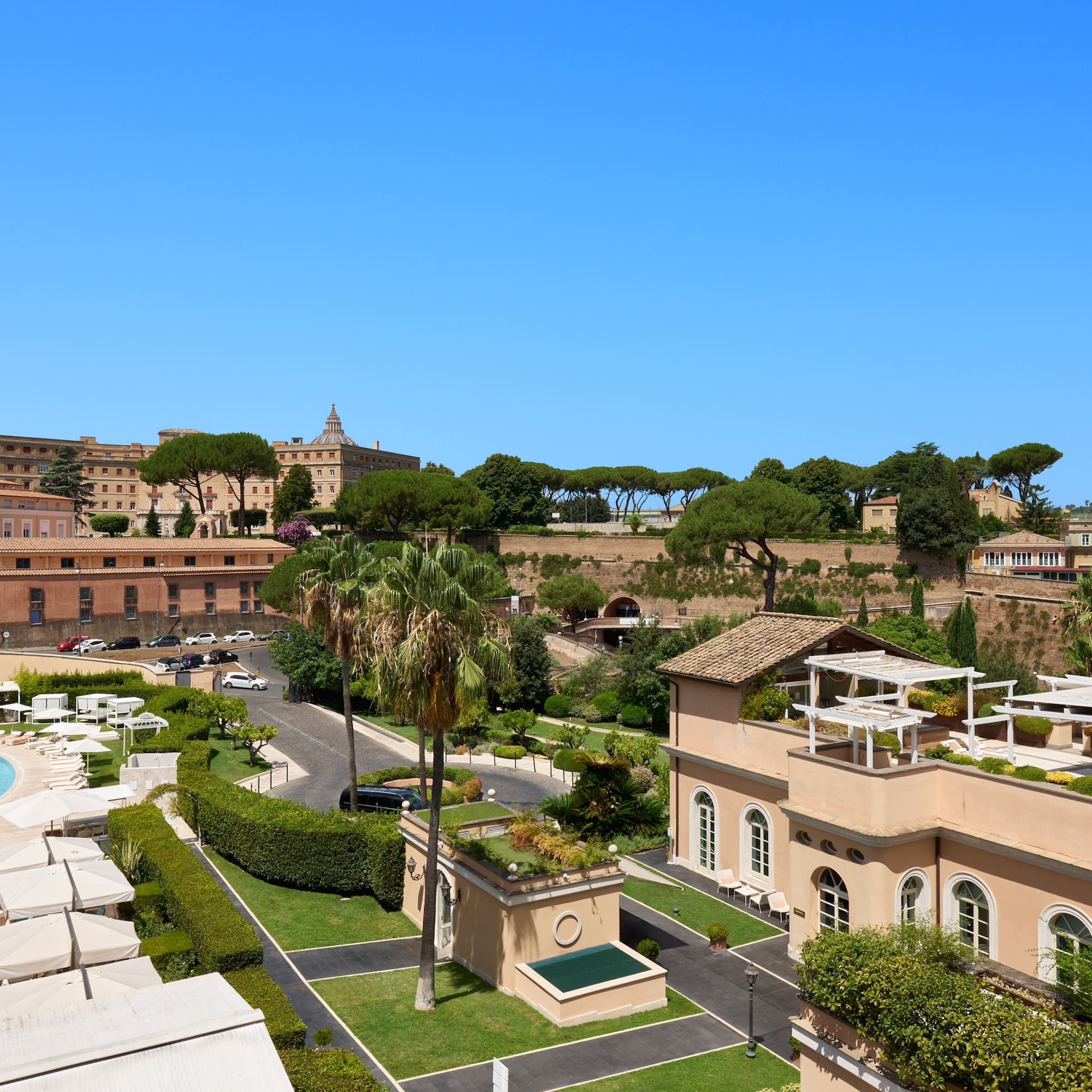 a group of buildings with trees and a pool