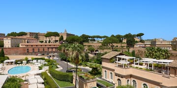 a group of buildings with trees and a pool