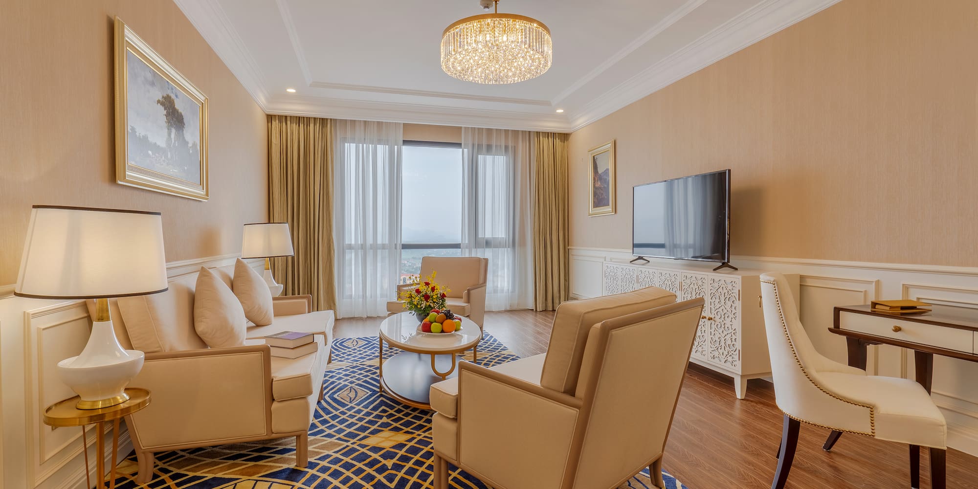 a living room with a chandelier and couches