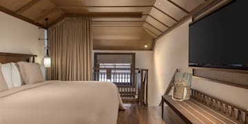 a room with a bed and a bench