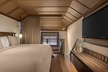 a room with a bed and a bench