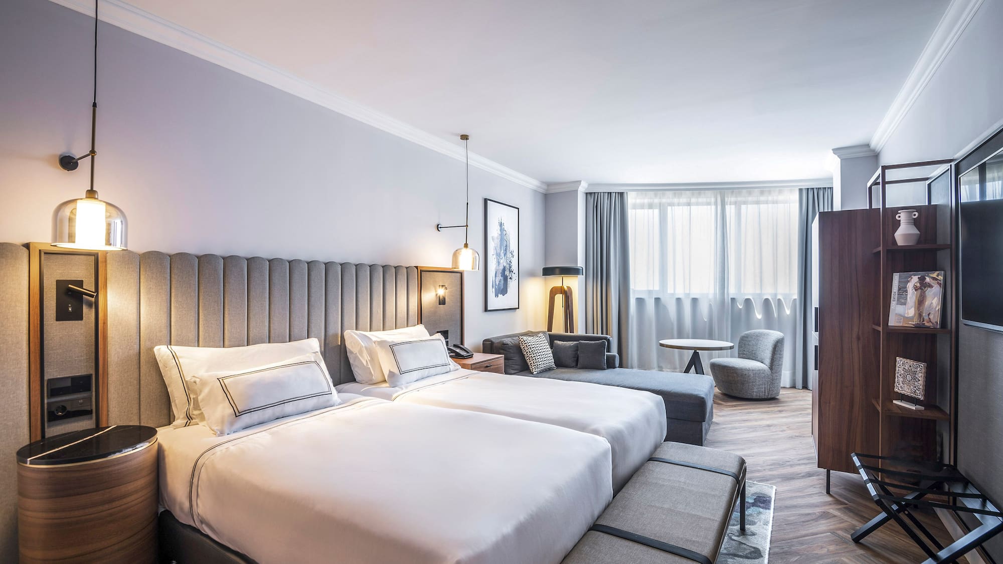 a hotel room with a bed and chairs