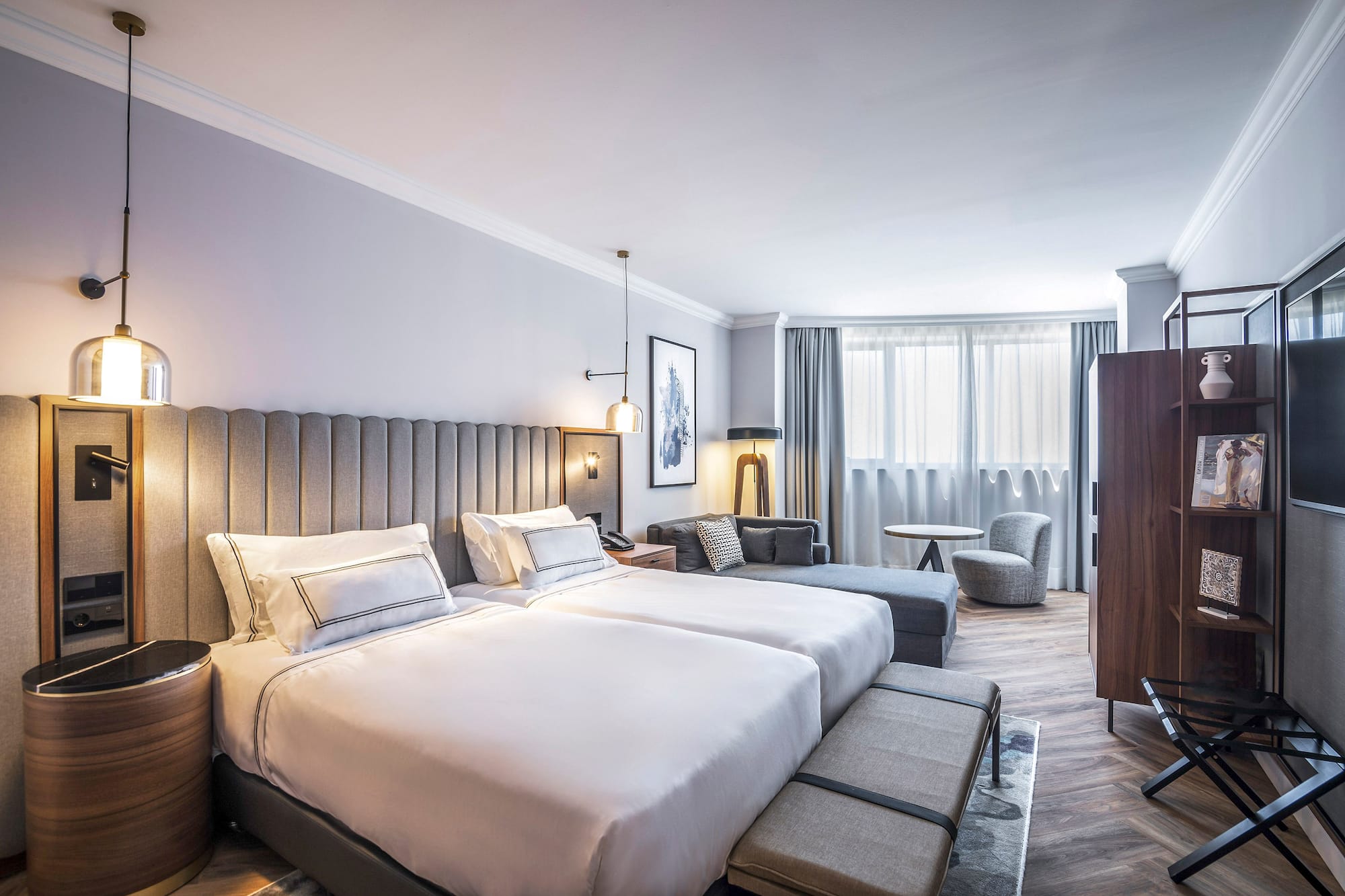 a hotel room with a bed and chairs
