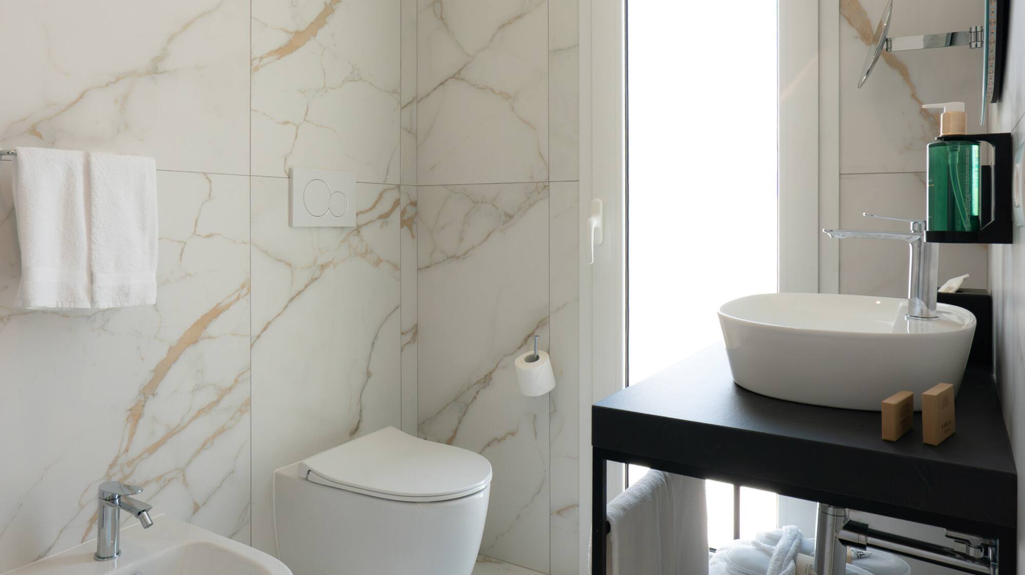 a bathroom with marble walls and a sink
