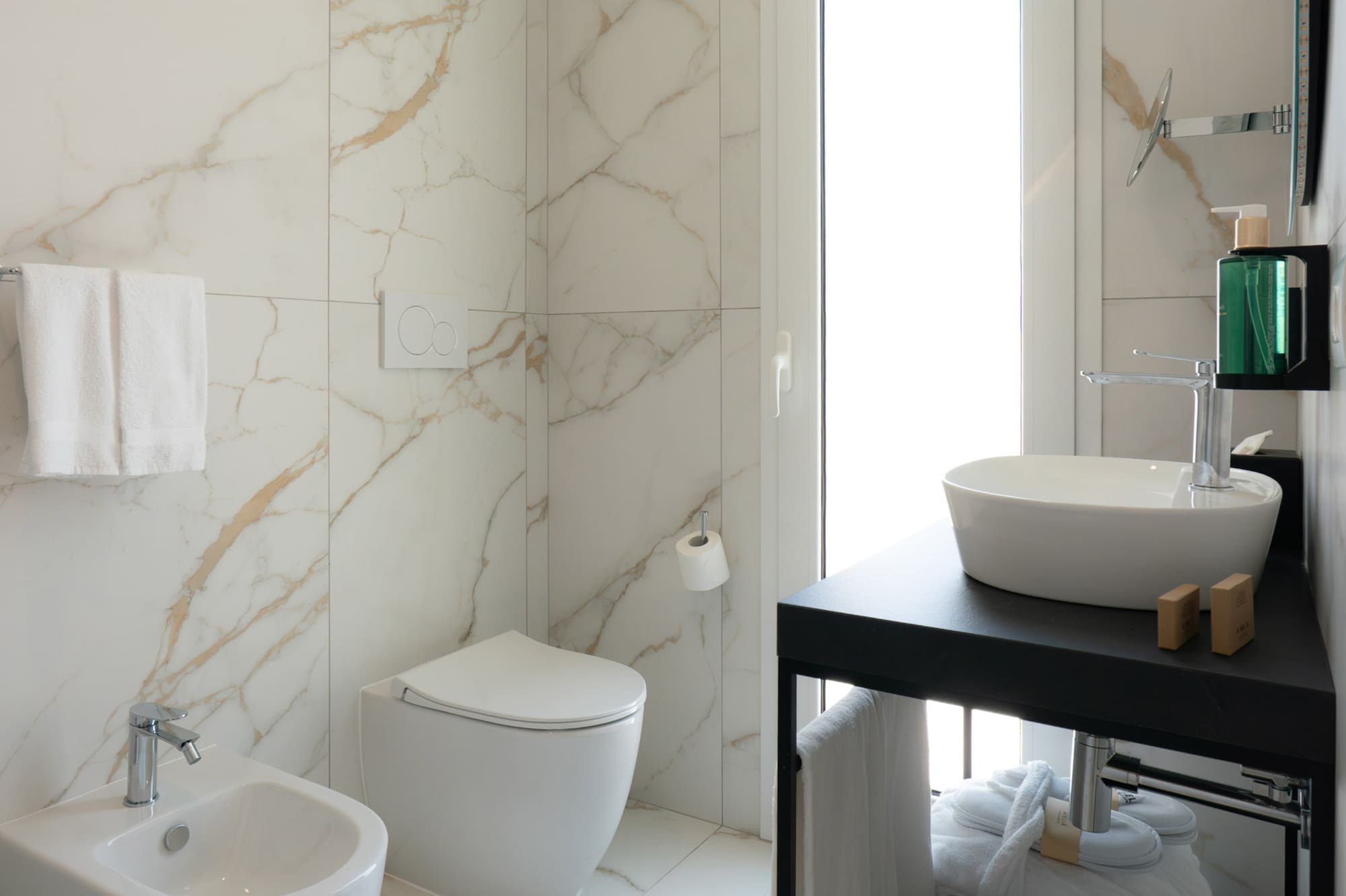 a bathroom with marble walls and a sink