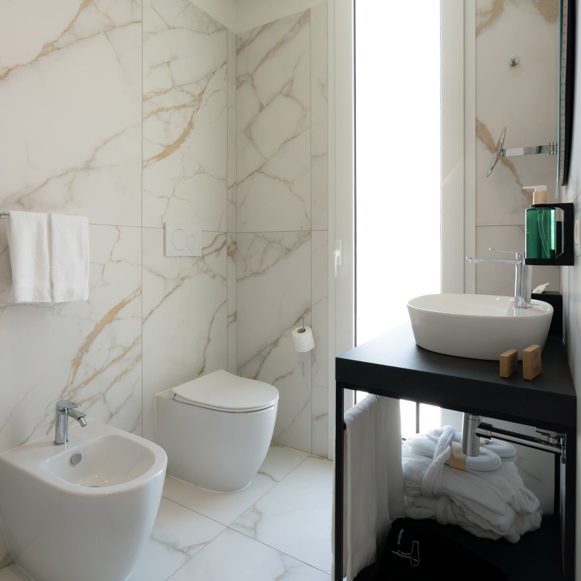 a bathroom with marble walls and a sink
