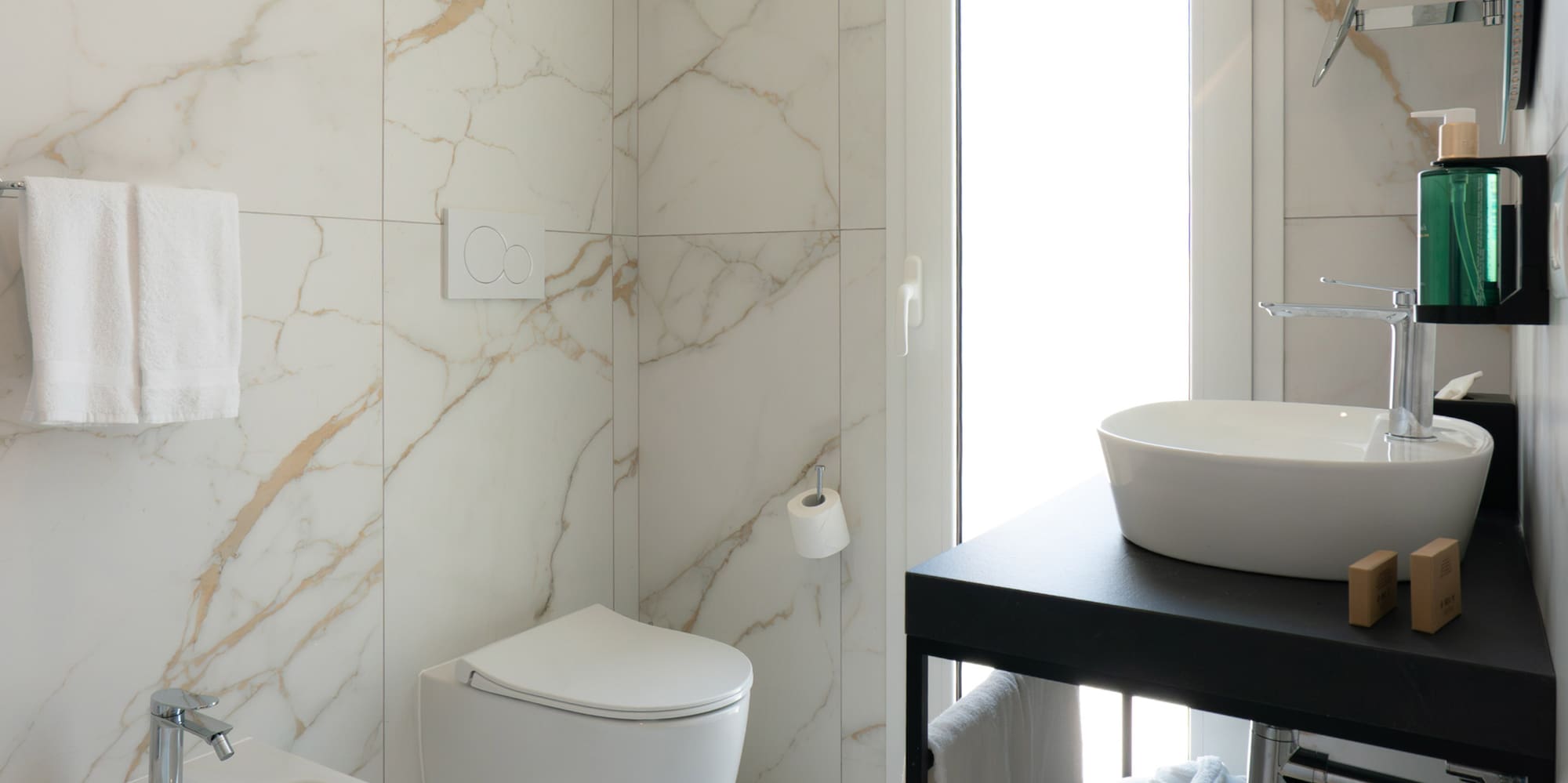 a bathroom with marble walls and a sink