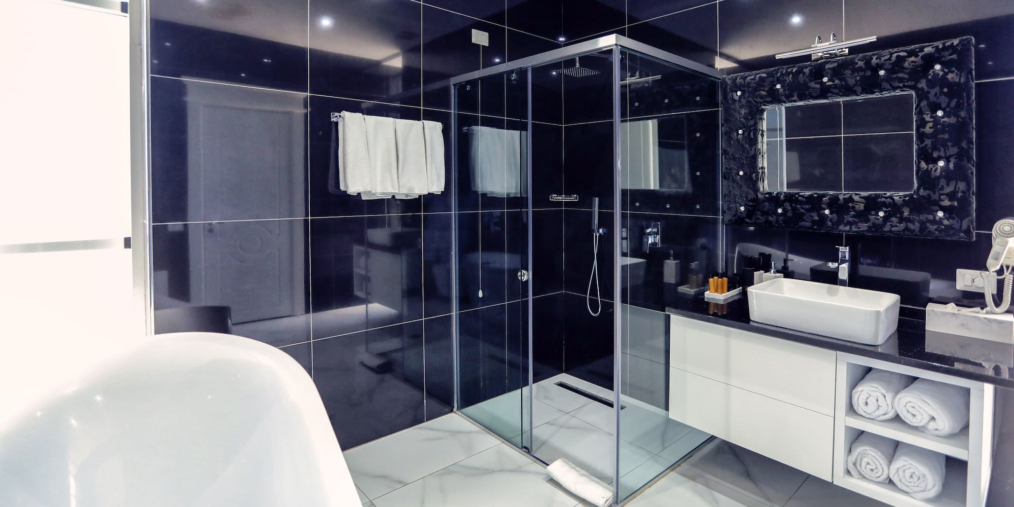 a bathroom with a glass shower and a bathtub