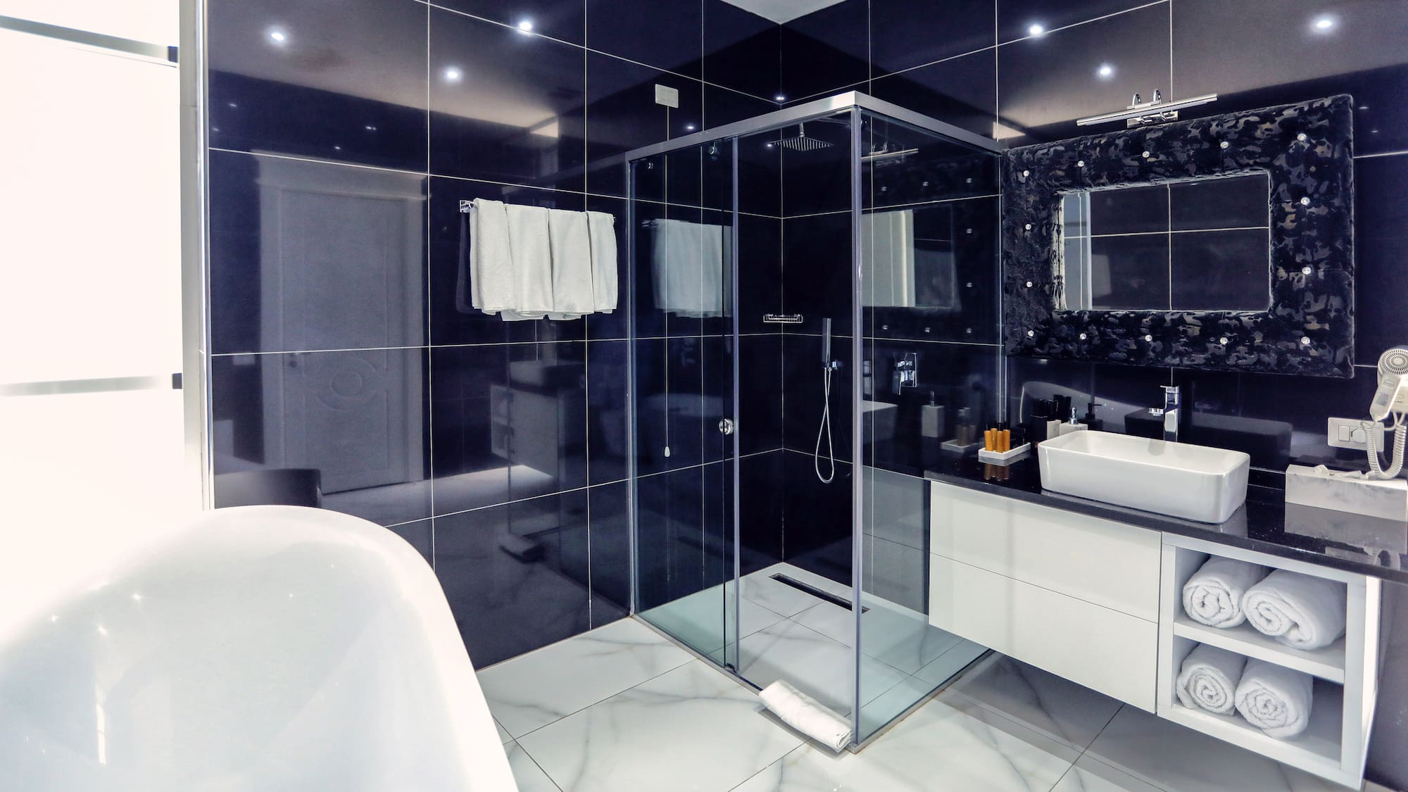 a bathroom with a glass shower and a bathtub