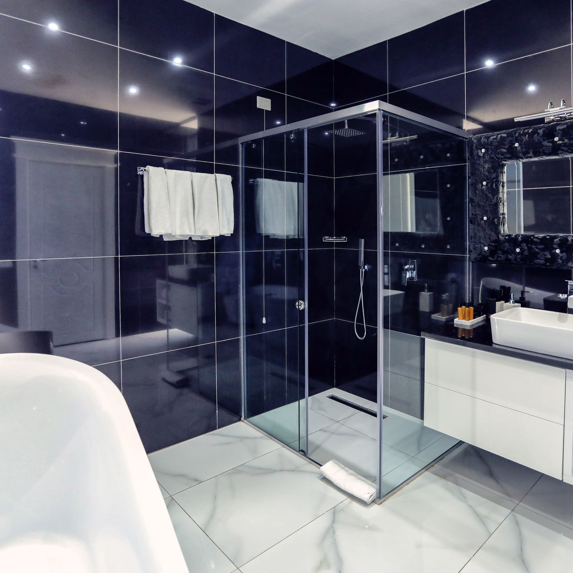 a bathroom with a glass shower and a bathtub