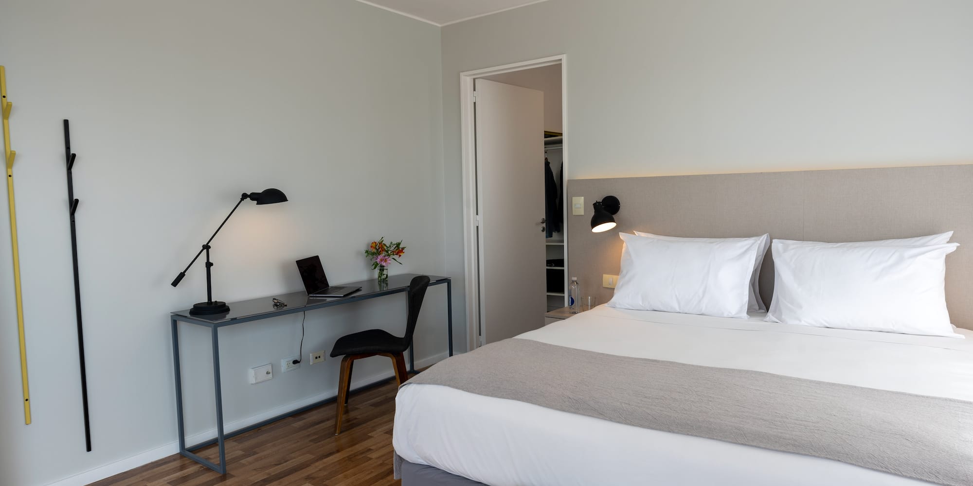 a bedroom with a bed and a desk