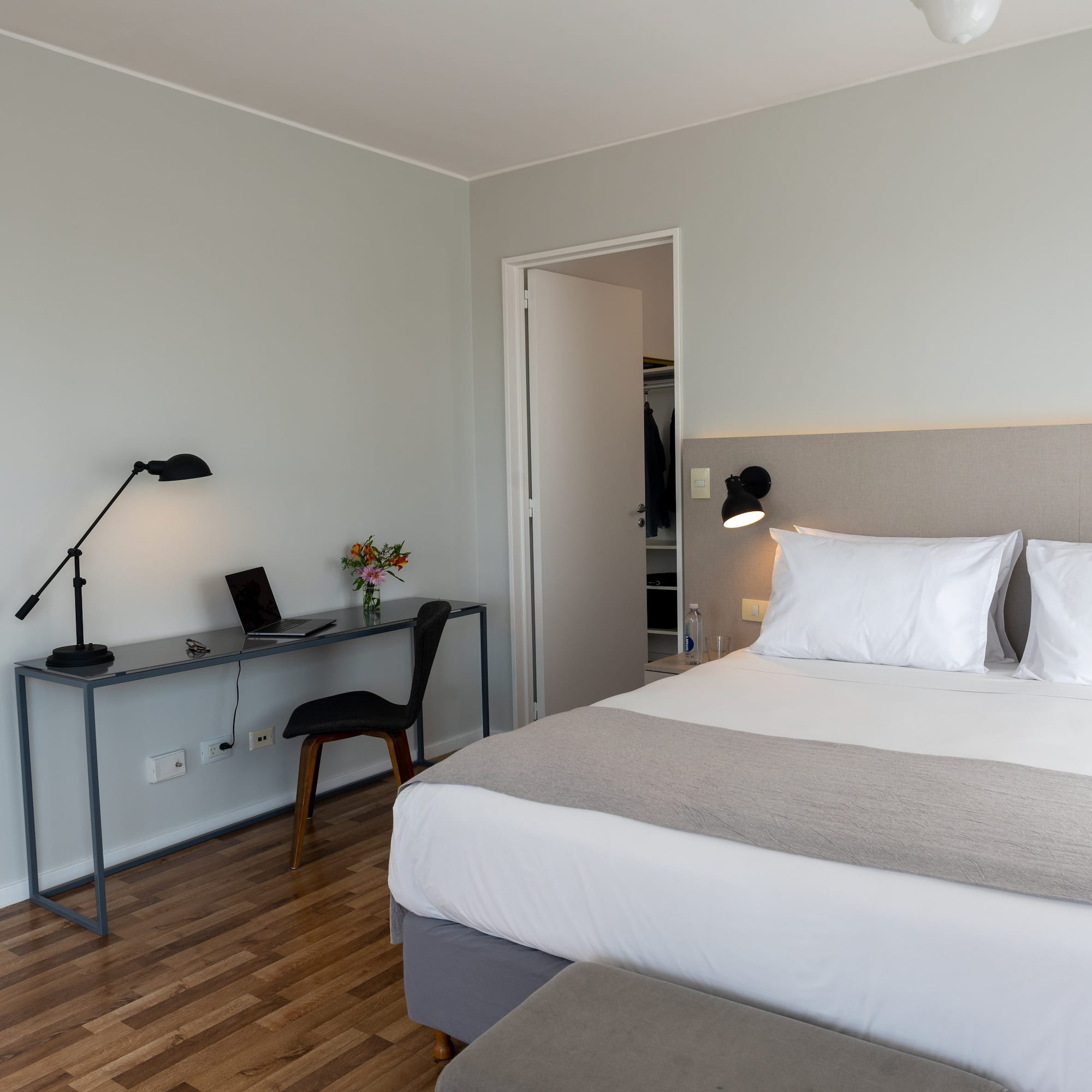 a bedroom with a bed and a desk