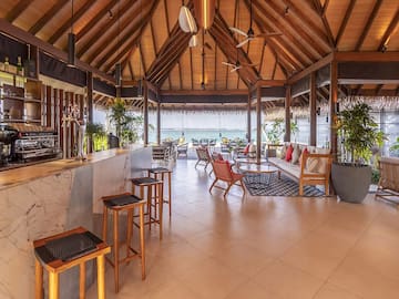 a room with a bar and chairs and a table