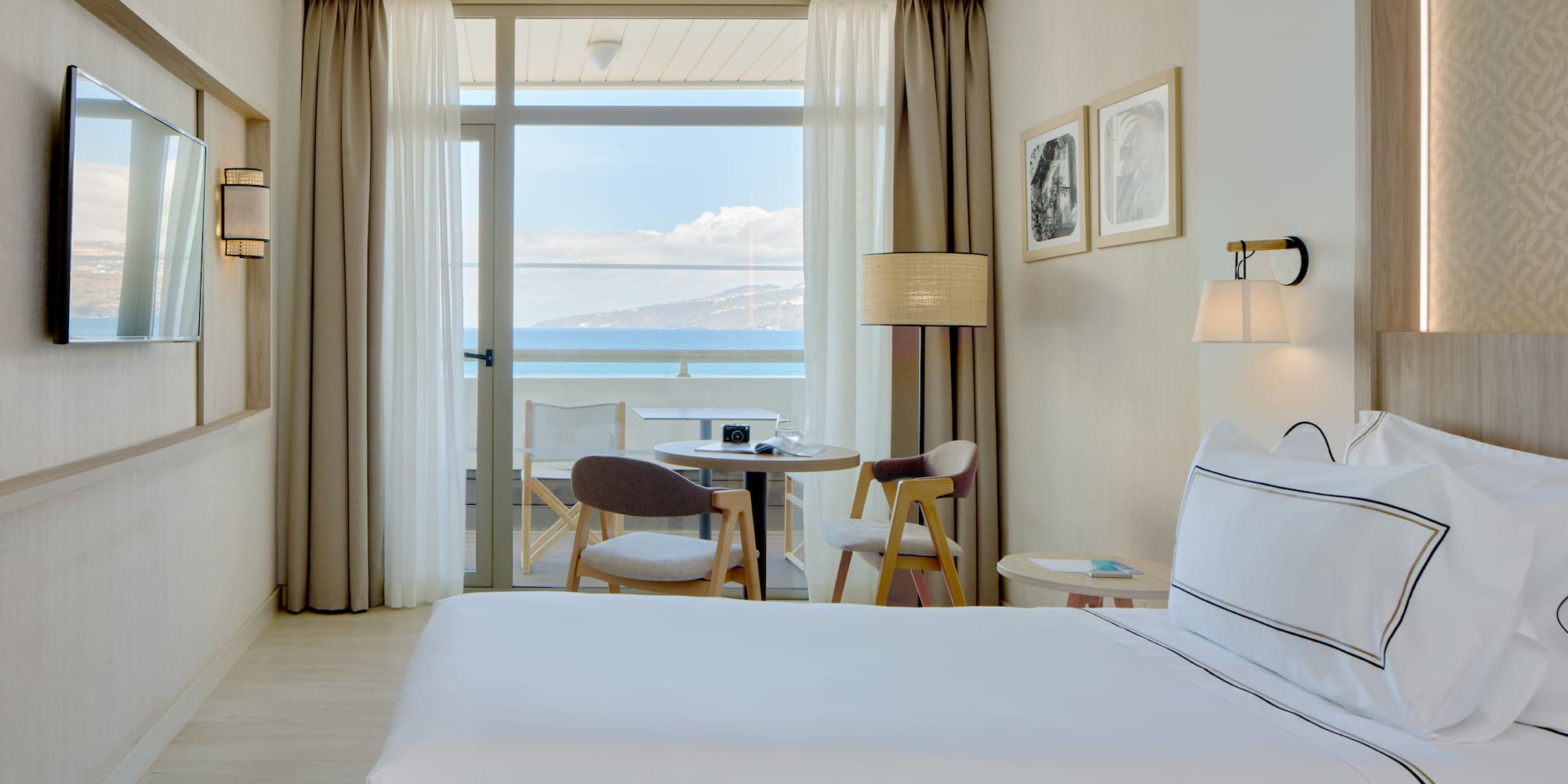 a hotel room with two beds and a table and chairs