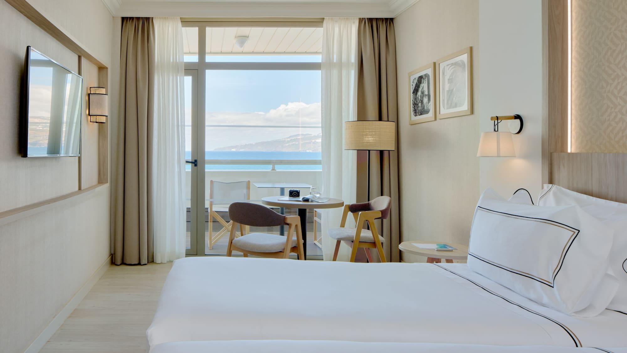 a hotel room with two beds and a table and chairs