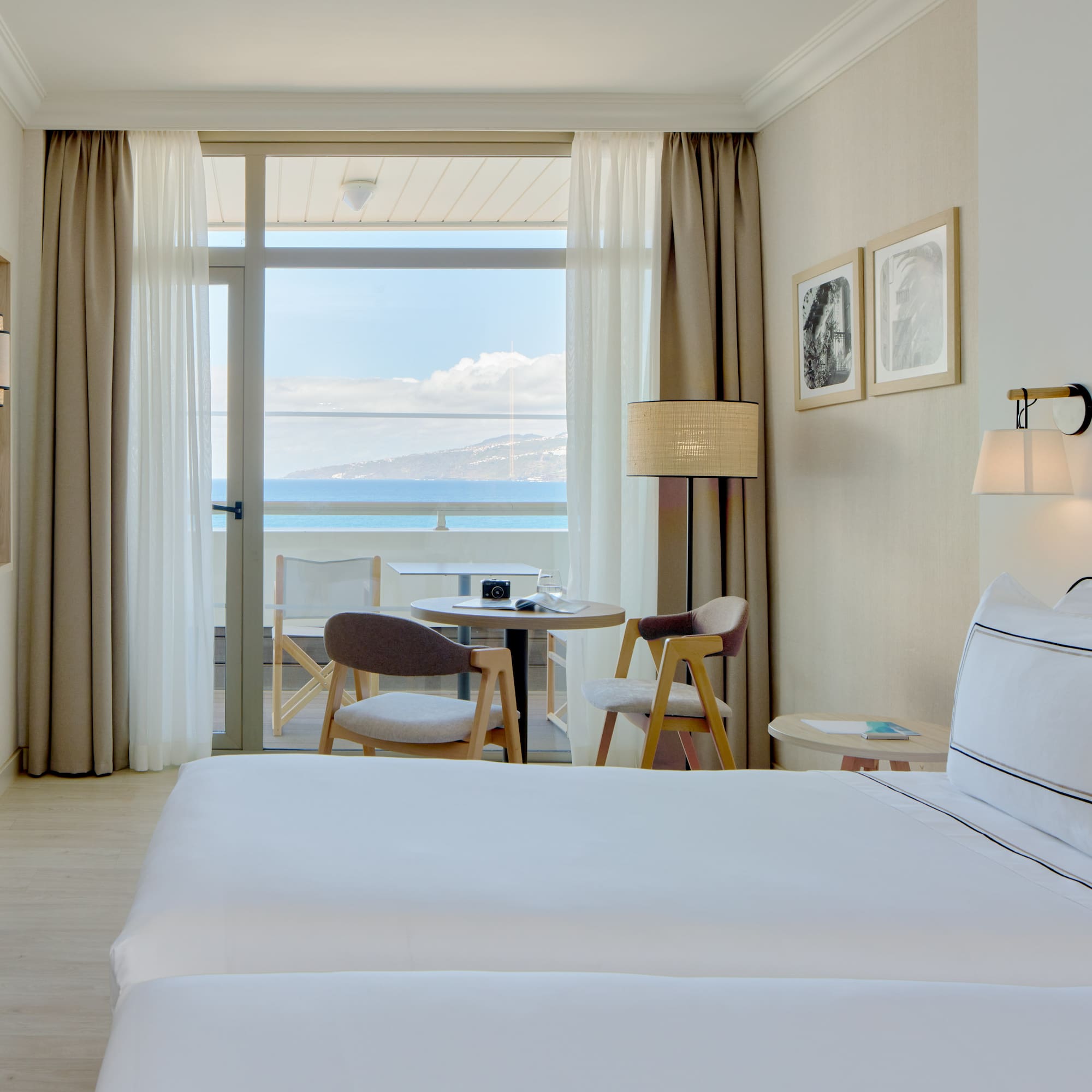 a hotel room with two beds and a table and chairs