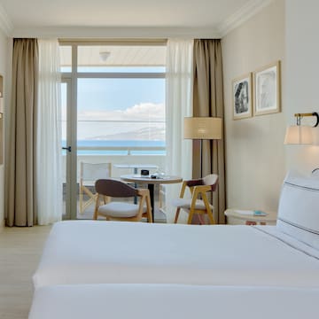 a hotel room with two beds and a table and chairs