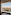 Hotel room with panoramic Paris view, Eiffel Tower, and Seine River.