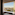 Hotel room window with Paris cityscape, Eiffel Tower, and Seine River view.